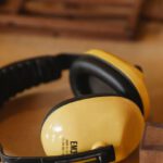 Noise-Cancelling Headphones - Protective headphones for woodwork on wooden table