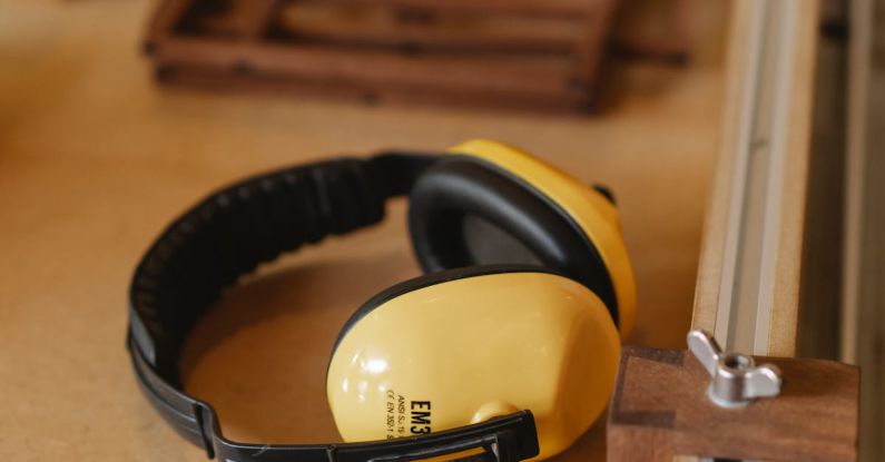 Noise-Cancelling Headphones - Protective headphones for woodwork on wooden table
