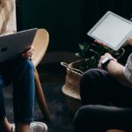 Home Automation Gadgets - Photo of Couple Talking While Holding Laptop and Ipad