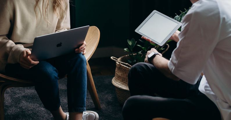 Home Automation Gadgets - Photo of Couple Talking While Holding Laptop and Ipad