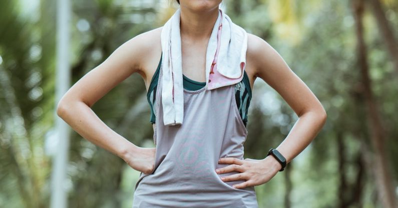 Wearable Cameras - Asian female athlete resting after workout in park