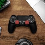 Gadgets - Black Game Console on Wooden Surface