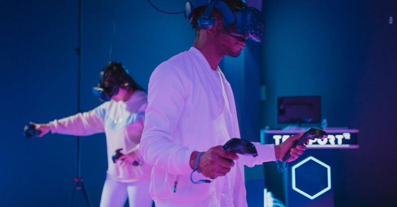 Consoles - Man Playing a Video Game while Wearing a VR Headset