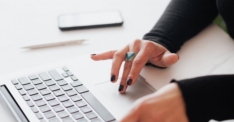 Smart Blinds - Crop female using touchpad on laptop in office