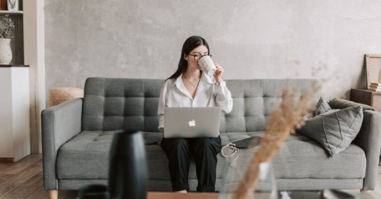 Educational Software - Woman Drinking Coffee While Working With Laptop