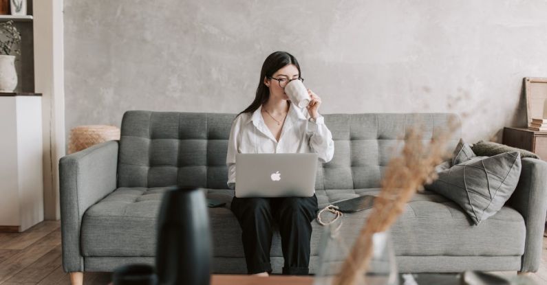 Educational Software - Woman Drinking Coffee While Working With Laptop