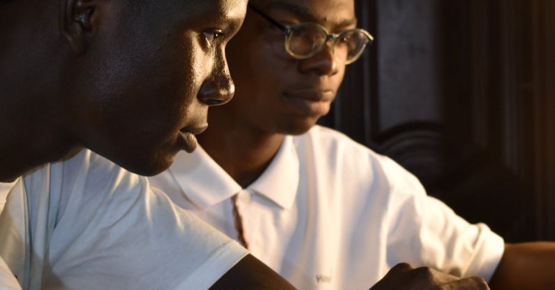 Translation Devices - Two young men are working on a laptop